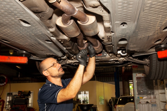 vehicle repair mechanic providing sunshine coast car exhaust repairs underneath vehicle