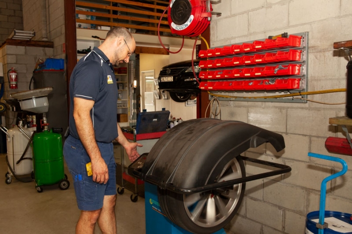 nambour tyre mechanic checking tyre pressure of detached tyre to do wheel balancing wheel alignment